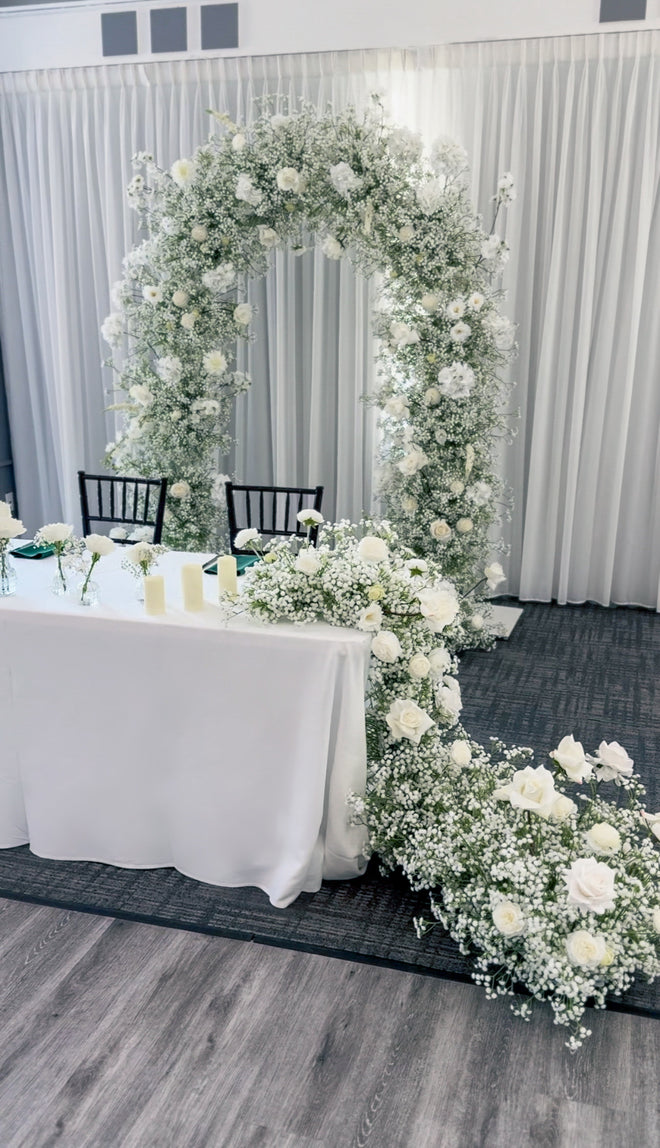 Cascading sweetheart table arrangement